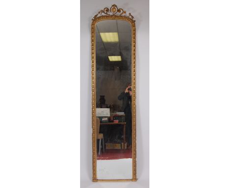 A Victorian giltwood and gesso wall mirror, the rectangular arched plate surmounted with a flower head and C scroll moulded p