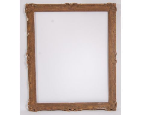 An early 20th century gilt gesso picture frame, having leaf and flower head swept corners and edges (with losses), gross dime