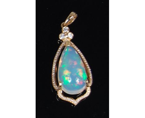 An 18ct gold and Ethiopian opal set pendant, the large three claw set cabochon opal weighing approx 8ct within a surround of 