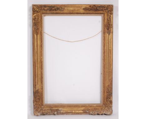 A 19th century French giltwood and gesso picture frame, having flower head carved and swept corners and acanthus leaf moulded