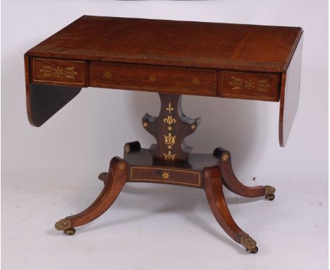 A good Regency rosewood and brass inlaid pedestal sofa table, having blind frieze drawer, lyre shaped pedestal to a quatrafor