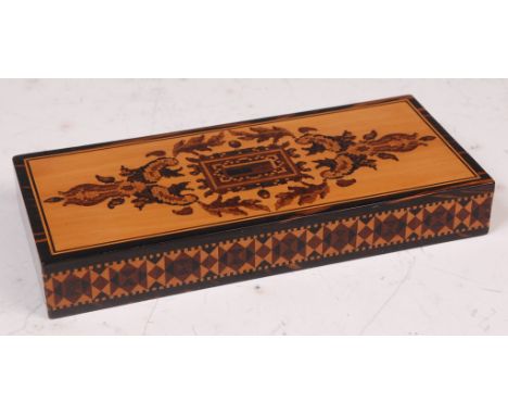 A late Victorian lignum vitae and Tunbridge ware paperweight, the top decorated with stylised leaves and flowers, the frieze 