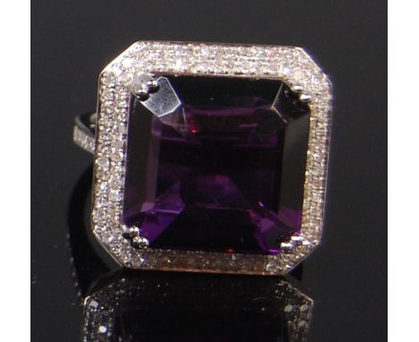 A contemporary 14ct white gold amethyst and diamond cocktail ring, the four claw set square cut purple amethyst weighing appr