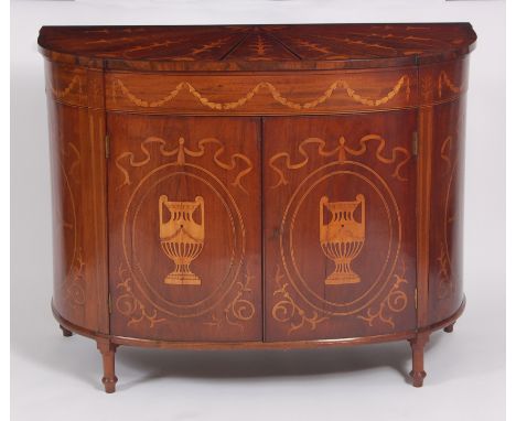 An antique mahogany and marquetry inlaid commode, showing Sheraton influence, the top with fanned marquetry panels above a ba
