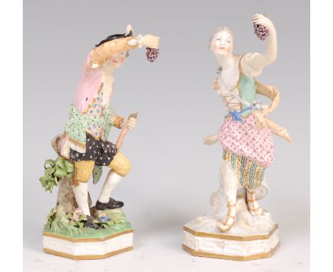 A pair of 19th century Meissen figures of a gallant and his companion, each holding aloft a bunch of grapes, decorated in bri