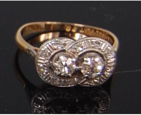 A ladies 18ct gold and platinum diamond two stone ring, arranged as a pair of claw set old brilliants, each weighing approx 0