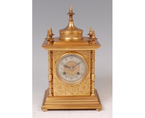 A late 19th century gilt brass cased mantel clock, the case having five turned finials and ring turned columns flanking silve