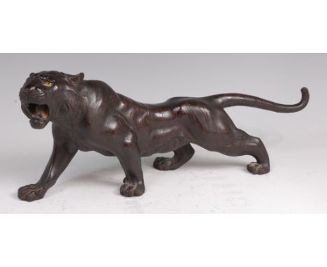A Japanese Meiji period bronze tiger, naturalistically modelled in roaring stance, with textured markings, signed verso, havi