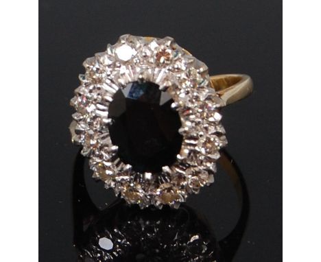 A Victorian style ladies 18ct gold sapphire and diamond cluster ring, arranged as a raised oval cut sapphire weighing approx 