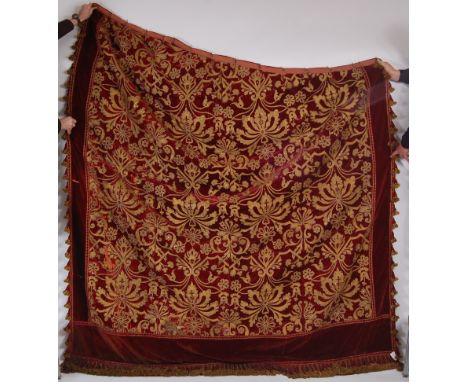 An 18th century  Italian crimson silk velvet single curtain made up for four panels.  The velvet is appliqué with gilt metal 