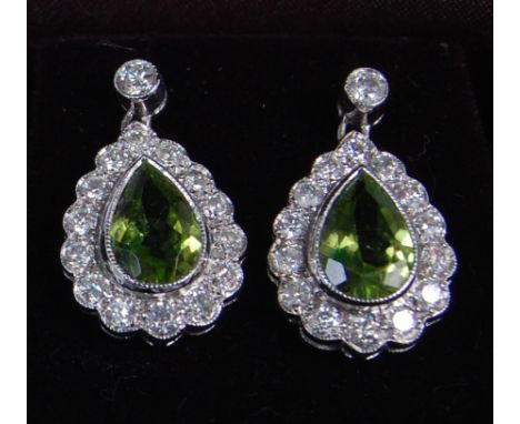 A pair of ladies 18ct white gold green peridot and diamond set ear pendants, the pear cut peridot each weighing approx 1.5ct,