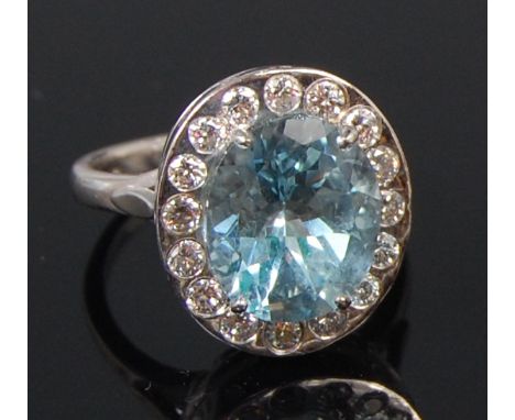 A ladies 18ct white gold aquamarine and diamond set dress ring, the four claw set oval cut aquamarine weighing approx 4ct, wi