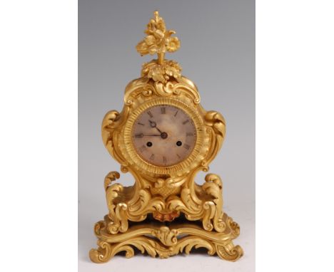 A mid-19th century French gilt bronze Rococo Revival mantel clock, the floral finial over scroll flower case to integral base