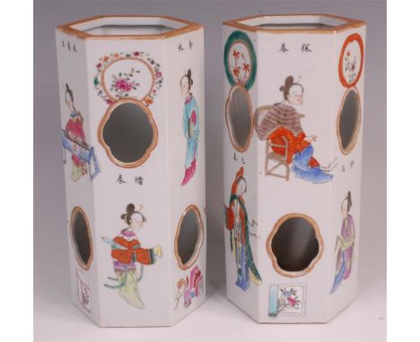 A pair of circa 1900 Chinese hexagonal vases, each decorated in the famille rose palette with figures and objects, seal mark 