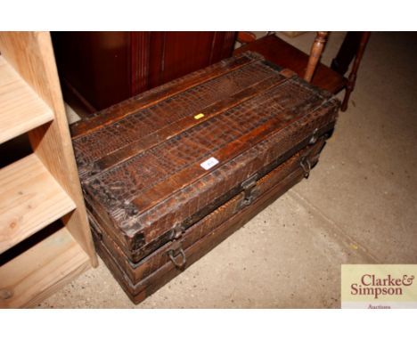 A wooden bound crocodile skin effect travelling trunk 