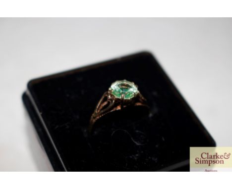 A 9ct gold green stone set ring with pierced shoulders 