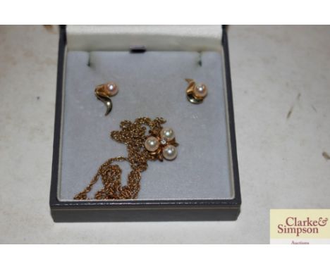 A yellow metal pearl set ear-ring and necklace set