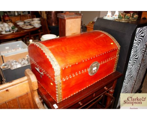 A red lacquer decorated domed trunk 