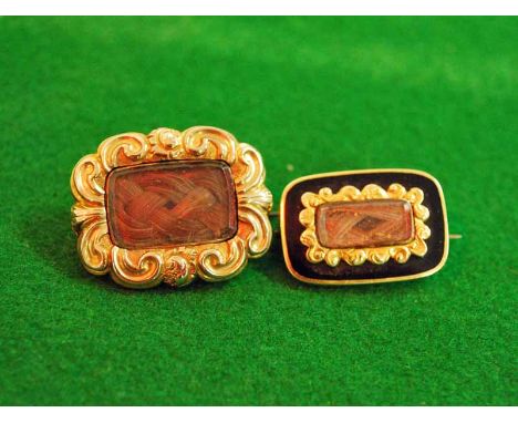 A Victorian yellow metal Memorial Brooch with rectangular locket inset with woven hair plait, within a border of scroll work,