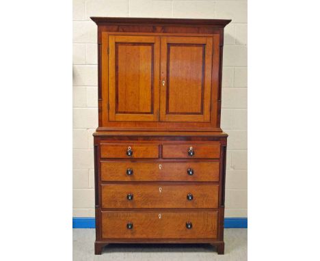 A handsome Georgian oak and mahogany Cabinet over Chest, the upper portion with moulded cornice over a pair of panelled doors