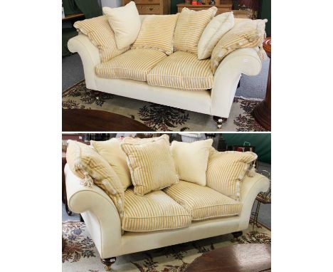 A Pair of 20th Century Two-Seater Sofas, upholstered in light yellow fabric, on Victorian style forelegs with castors, 190cm,