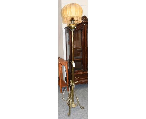 An Art and Crafts Telescopic Brass Oil Lamp, converted for electricity, supported upon three floral legs, 167cm lowest height