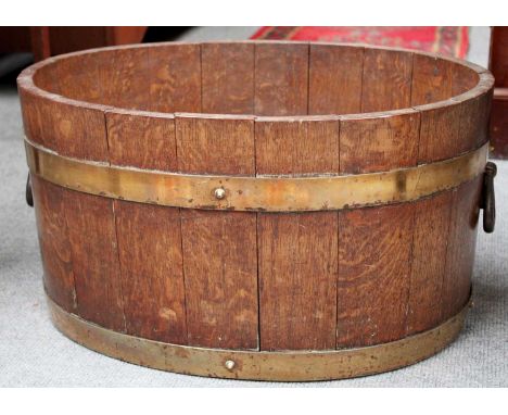 An Early-20th Century Coopered Oak Planter, with twin iron handles, bearing label, R A Lister &amp; Co, Ltd Dersley
