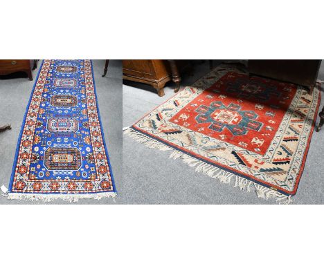 A Kozak Anatolian rug, the blood red field with two stellar medallions enclosed by leaf and calyx borders, 155cm by 144cm; to