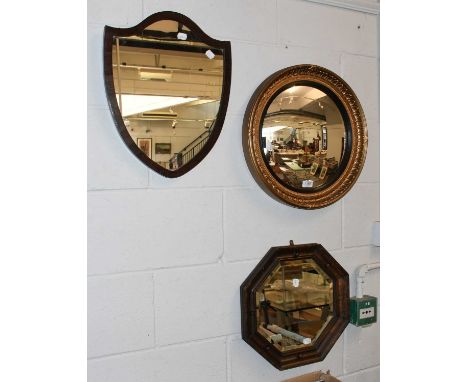 An Edwardian Shelf Form Mirror, a 1920's oak octagonal mirror and a regency style gilt and ebonised convex mirror