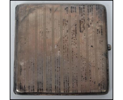 An early 20th century George V cigarette case by Stewart Dawson &amp; Co Ltd having an engine turned decoration with blue ena