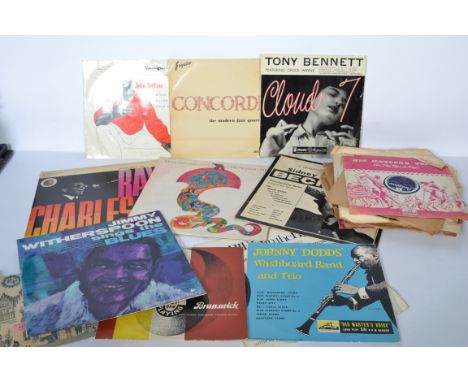 A collection of vintage 78rpm shellac and long play vinyl records predominately jazz records by various artists. 