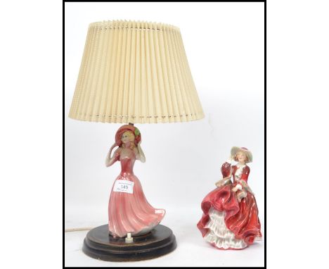 A Royal Doulton ceramic figurine Top O The Hill HN1834 red colourway along with a ceramic figurine lamp possibly Doulton. Mea