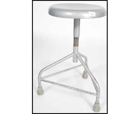 A vintage retro 20th century industrial medical stool raised on a tubular tripod base with revolving metamorphic seat. Measur