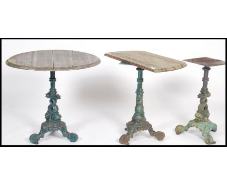 A series of 3 cast iron garden tables with remnants of tops. Each with tripod bases having carp / dolphin uprights to each of
