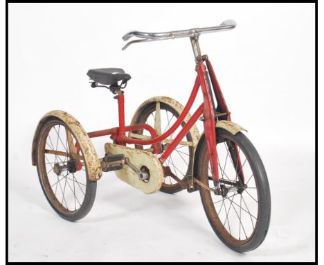 A vintage early 20th century childs tricycle - trike in red and white two tone colourway, dunlop saddle and rubber hard wheel