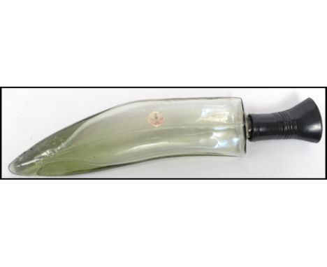 A vintage 20th century studio art glass decanter in the form of a large Kukri knife&nbsp; with applied Nepal Distilleries lab