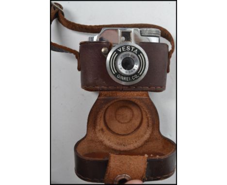 A vintage Vesta GRC Ginrei F-20 mm miniature camera complete with leather case. In the case measures 4.5 cm high, 6.5 cm wide