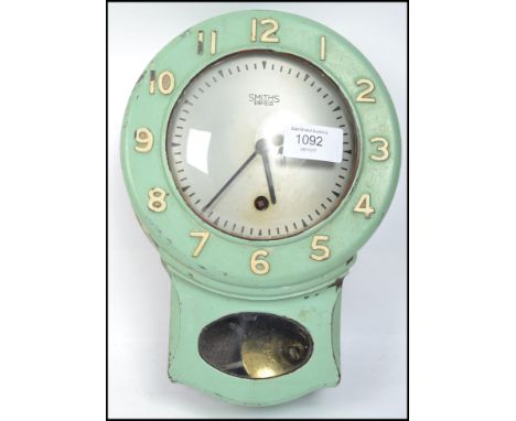 A vintage mid 20th century Smiths Enfield bakelite wall clock having an 8 day movement with green painted finish. 26cm tall.&