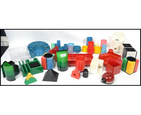 A collection of vintage 20th century retro desk top stationary items to include various stacking, metamorphic and coloured pi
