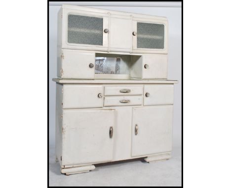 A 1930's Art Deco painted French kitchen dresser cabinet. The base with shaped bracket feet supporting a series of cupboards 
