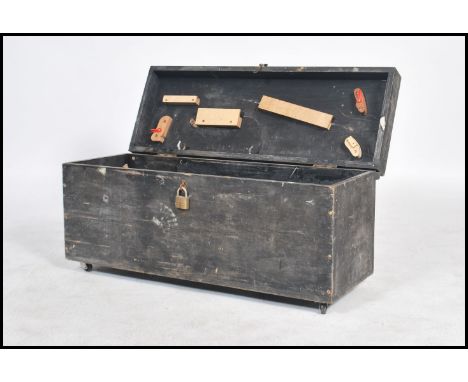 A vintage 20th century ebonised tool box having a hinged lid opening to reveal a spacious interior with fitted sides and lids