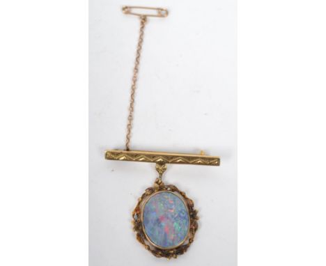 A 9ct gold and opal - doublet fob brooch having a chased decorated bar with an opal drop having a pierced surround. Weighs 5.