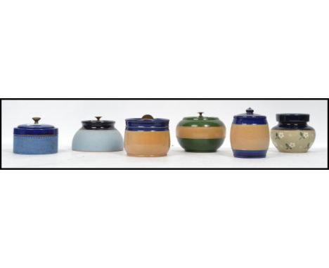A group of vintage 20th century ceramic tobacco jars to include Royal Doulton examples, each with lid. Highest measures 14 cm