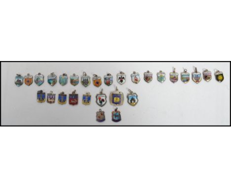 A collection of continental silver armorial shield enamel crest charms each stamped 800. Largest measures 2 cm high and 2 cm 