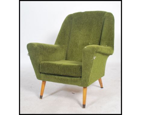 A vintage mid century 1950's armchair of continental French / Italian design in the manner of Ernest Race being raised on tur