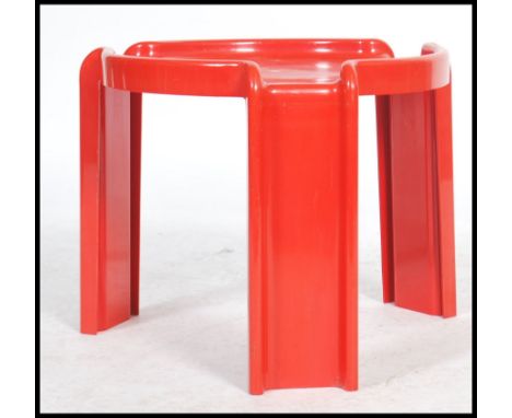 A vintage mid 20th century retro Kartell red plastic table, designed by Giotto Stoppino, circular on three moulded legs mould