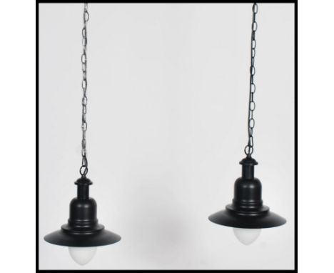 A pair of retro / vintage industrial style factory pendant of enamel metal in the UFO style. both in a black finish with a sc