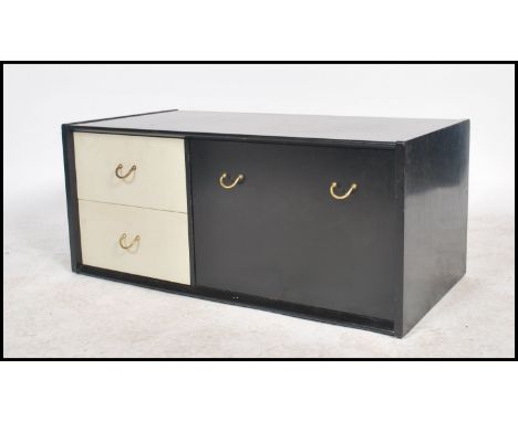 A vintage 20th century Ernest Gomme / G-Plan monochromatic coffee table, 2 drawers having a drop down cabinet. Measures: 40cm