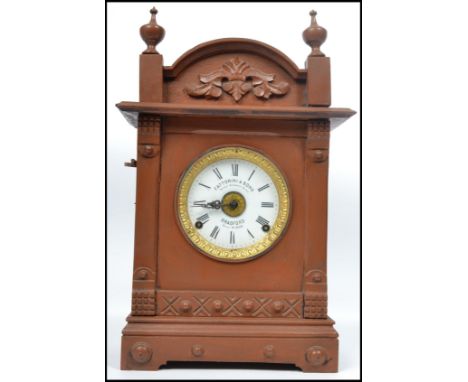 A late 19th century Aesthetic movement oak cased mantel clock, white enamel dial signed 'Fattorini &amp; Sons, Bradford havin