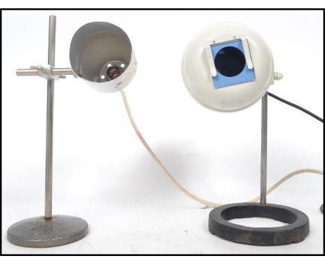Two vintage 20th century retro industrial laboratory lamps one being a Philip Harris raised on circular bases with adjustable